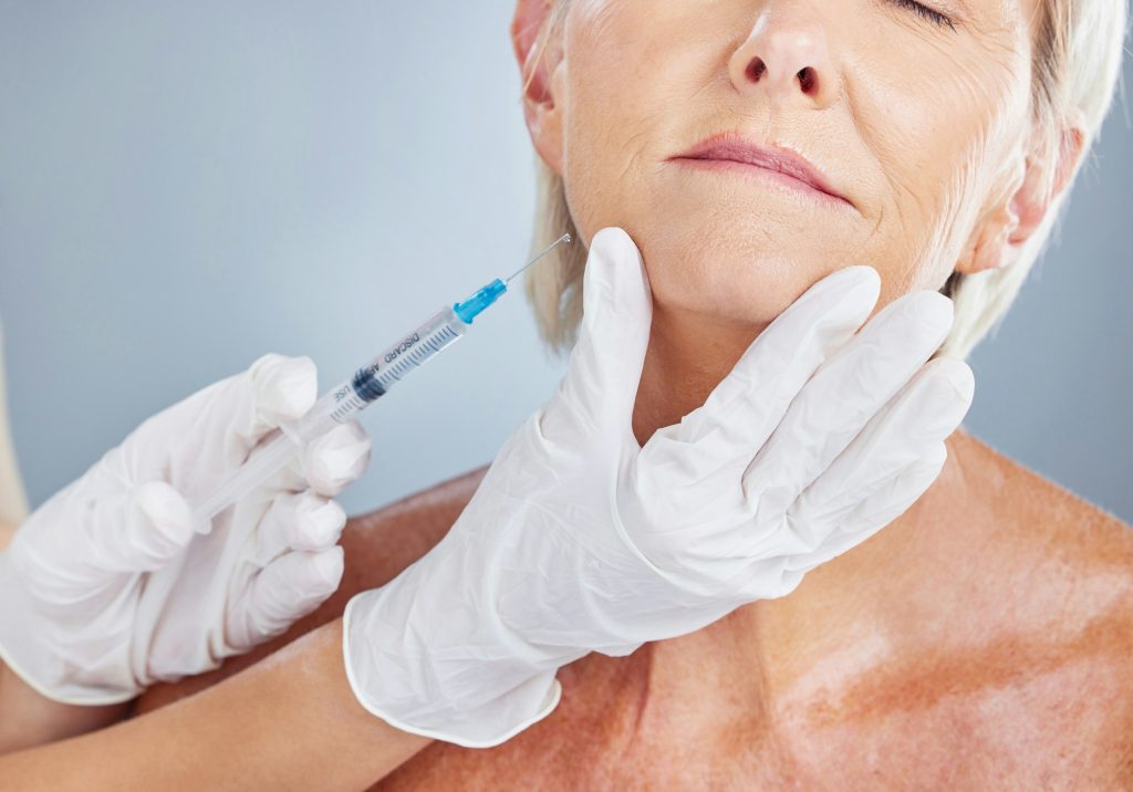 Botox, beauty and senior woman with plastic surgeon in a studio for skincare, cosmetic and wrinkles