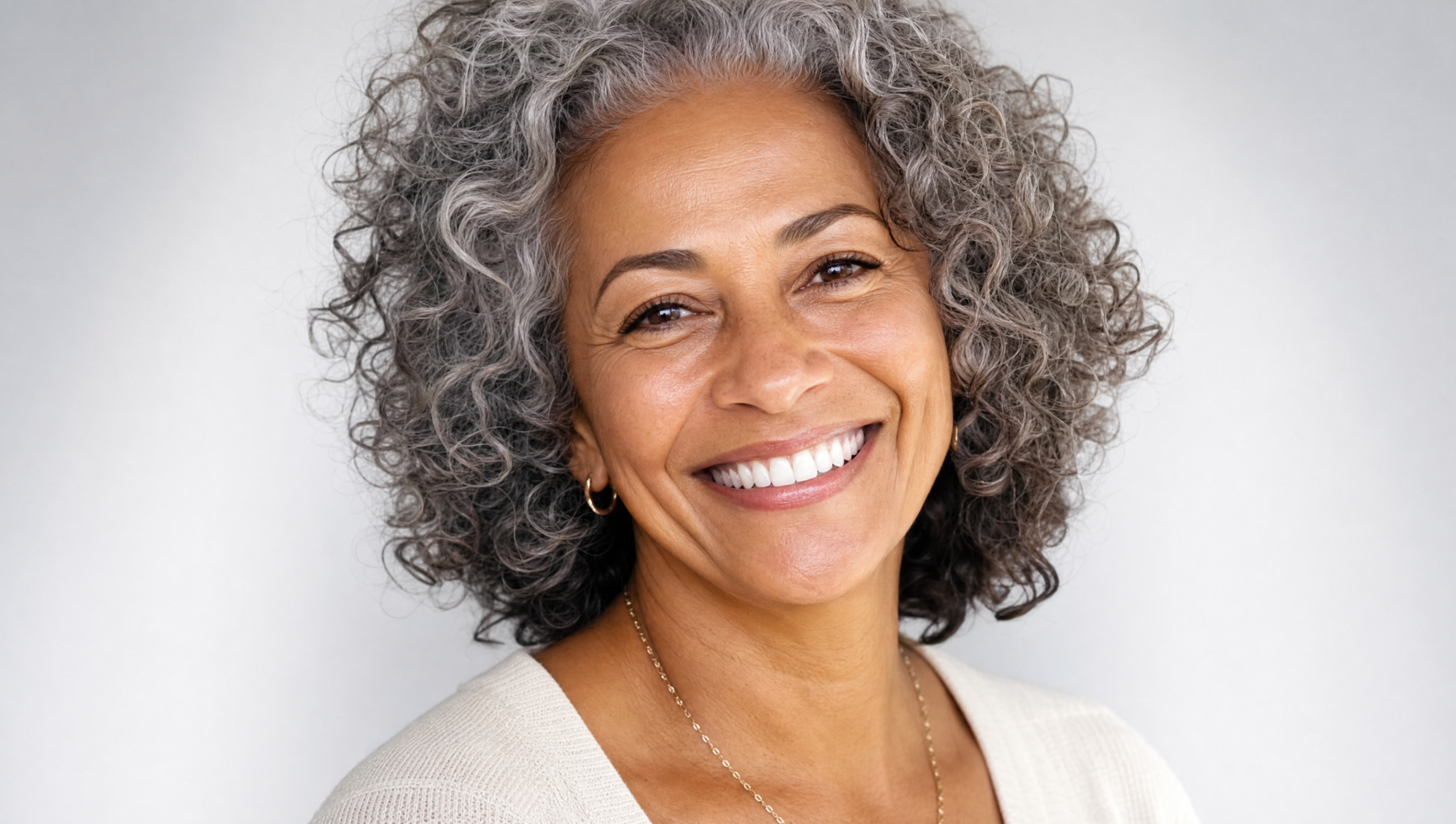 Happy dental implant patient in Tamarac FL with natural-looking restored smile