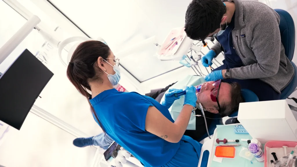 Home 6 Dentist and assistant treating a patient at Metropolitan Smile Design