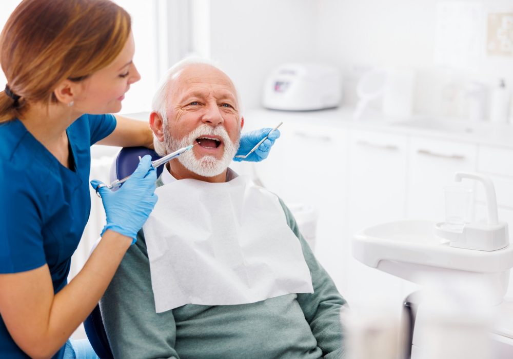 Dental care specialist applying local anesthetic to patient