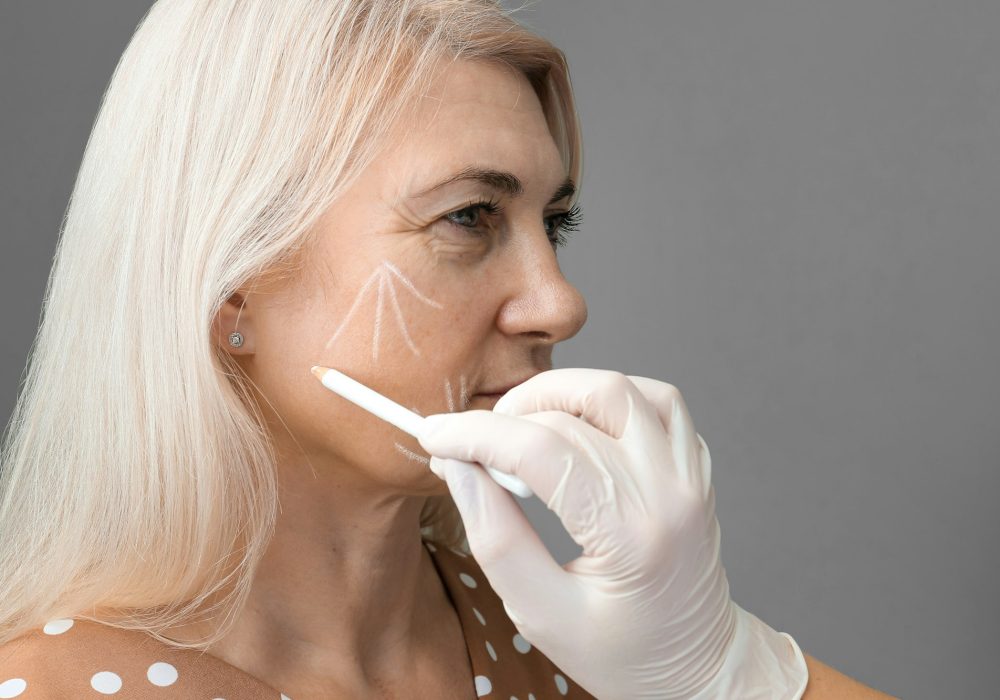 Marking the face with a white pencil for surgical intervention close-up