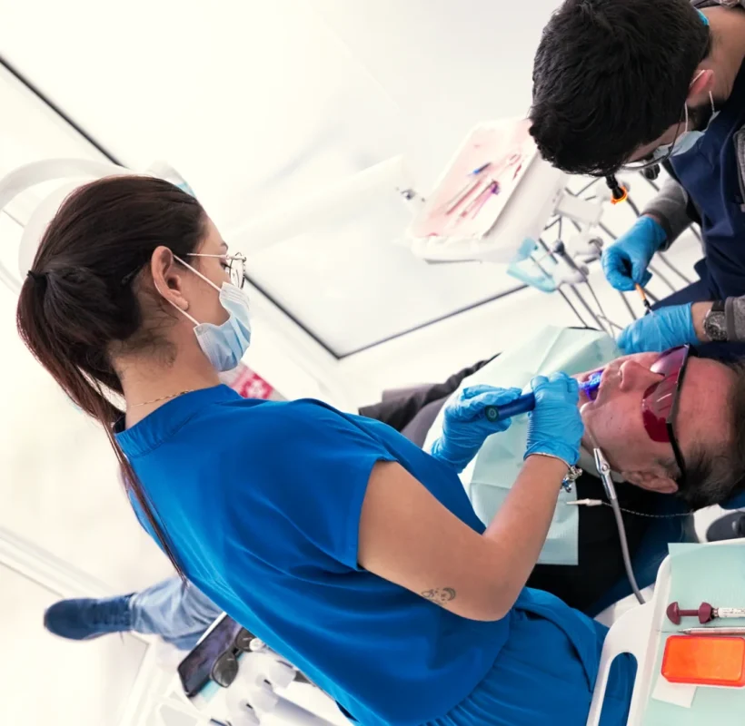 Dentist and assistant treating a patient at Metropolitan Smile Design, Tamarac FL