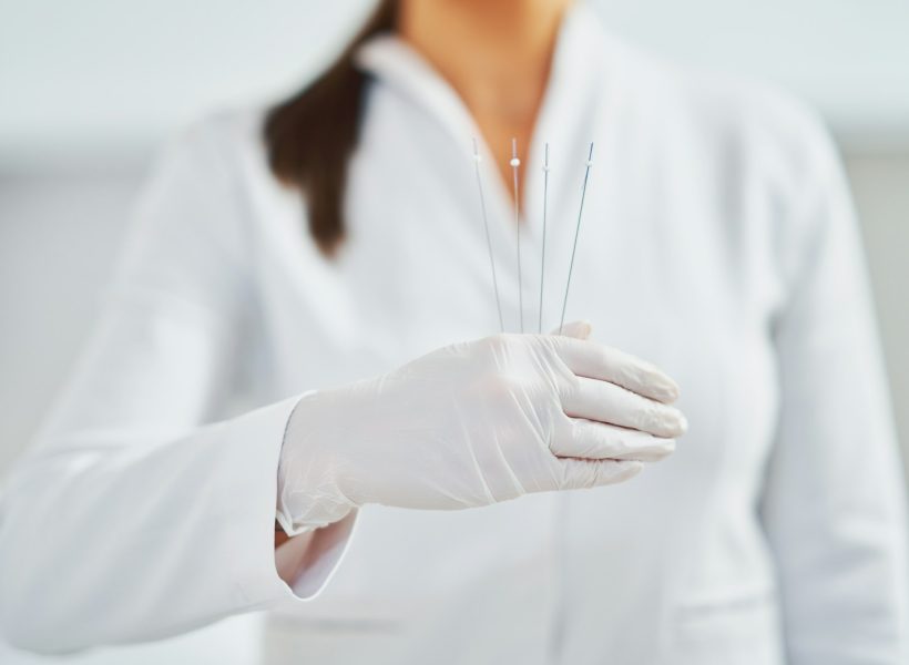 Picture of woman holding cosmetic threads in wearing gloves